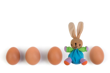 Happy Easter. brown easter eggs and rabbit on isolated white background. Copy space for text. Top view