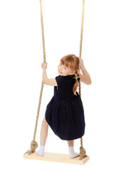 Little girl swinging on a swing