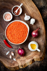 Cooking traditional red lentil Dal. Ingredients for Indian Dhal spicy curry. Top view, overhead