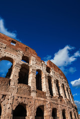 Obraz premium Coliseum inner ring monumental arcades and blue sky in Rome (with copy space above)