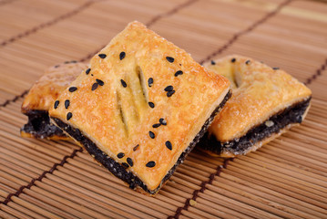 crispy pie with black sesame on wooden mat