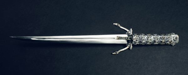 Metal sword on black background