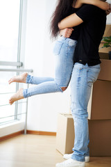 Happy couple at empty room of new home