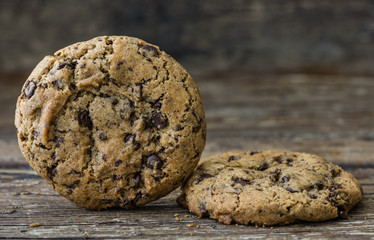 Two Freshly Baked Chocolate Cookies on Rustic Wooden Table. Sweet Biscuits. Homemade pastry.