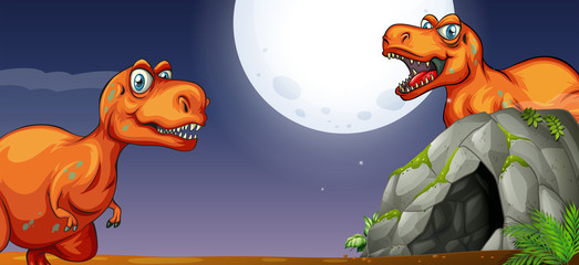 Two T-Rex by the cave at night © GraphicsRF