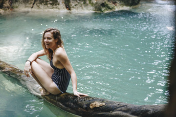 Woman sitting in a natural pond