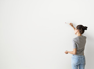 Artist woman painting the wall