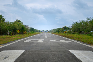 runway on small airfield in rural landscape with people