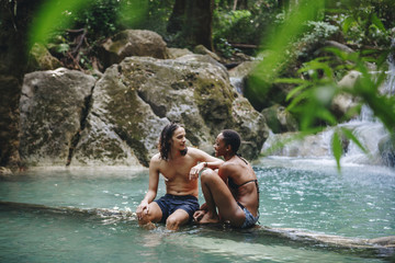 Fototapeta na wymiar Couple enjoying the waterfall