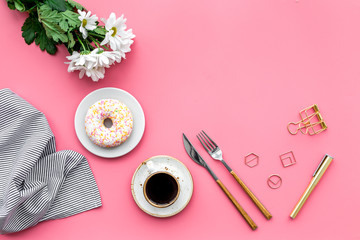 Obraz na płótnie Canvas modern breakfast desing with sweet donut, coffee and flowers on woman pink desk background top view mock up