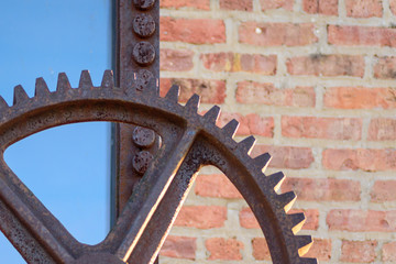 macro closeup of large rusty industrial gear outside factory