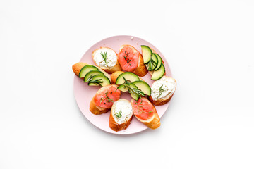 Mini sandwich set with french baguette, cheese, fish and avocado on white background top view mock up