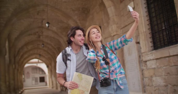 Young tourists taking a selfie in a picturesque medieval town