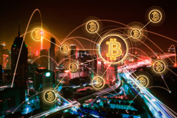 Fototapeta na wymiar Bitcoins and blockchain network connection with blur night city background .Electronic money ,blockchain transfers and finance concept.