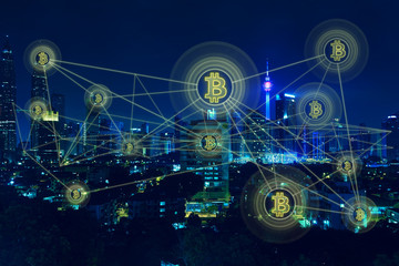Fototapeta na wymiar Bitcoins and blockchain network connection with night city background .Electronic money ,blockchain transfers and finance concept.