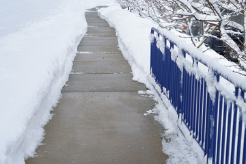 sidewalk with snow removed outside the building