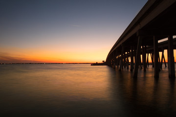 Fototapeta na wymiar vibrant sunset beneath the bridge