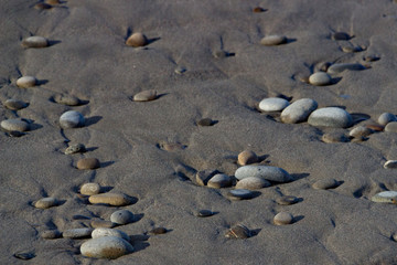Fototapeta na wymiar Beach rocks in the sand