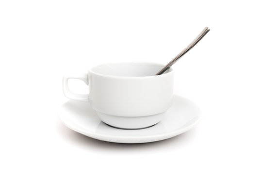 empty ceramic cup and saucer with teaspoon on white background