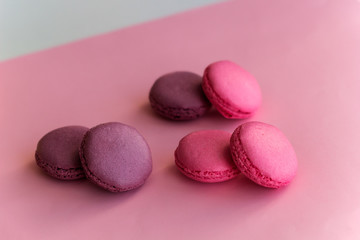 three pairs of swet macaroons pink background