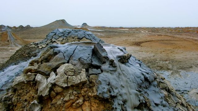 Boiling muddy bubbles in crater of mud volcano of Gobustan near Baku, Azerbaijan, v06
