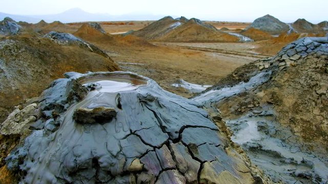 Boiling muddy bubbles in crater of mud volcano of Gobustan near Baku, Azerbaijan, v07