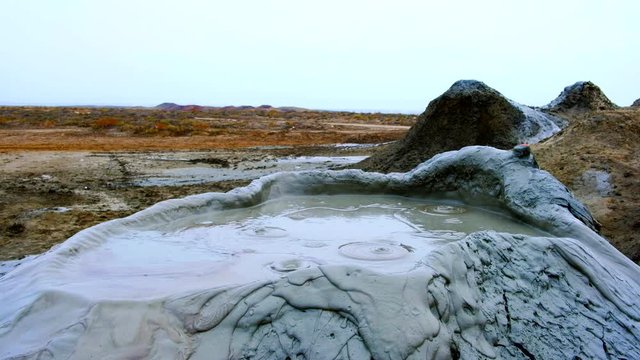 Boiling muddy bubbles in crater of mud volcano of Gobustan near Baku, Azerbaijan, v10