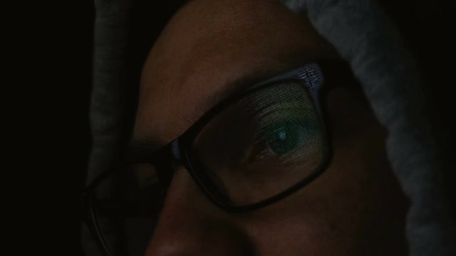 Command line is reflected in the programmer glasses close-up, 4k