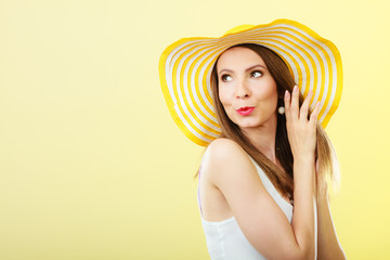 Woman in big yellow summer hat.