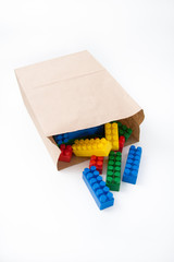 Colorful cubes in a paper bag on a white background