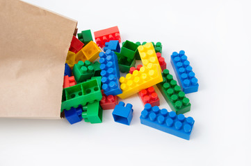 Colorful cubes in a paper bag on a white background