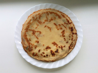 Pancakes in a plate on a white background