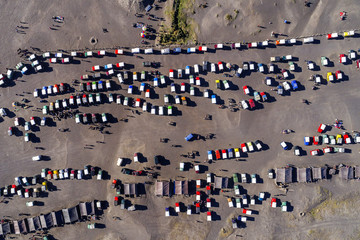 Aerial view of tourist jeeps waiting for people at parking lot in Bromo volcano, Indonesia