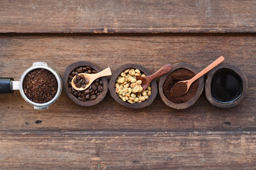 Close up of coffee beans and ground coffee in wooden bowl