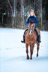 Fototapeta premium Happy young lady riding a horse.