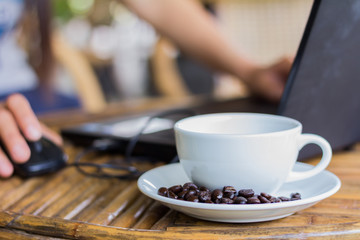 Young woman using laptop computer. Female working on laptop in an outdoor cafe.