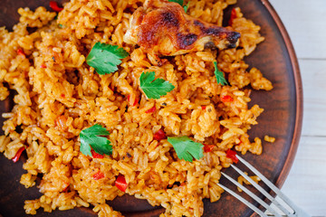 Fried rice with vegetables and chicken on a wooden table