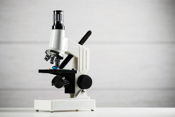 Laboratory Microscope, pills and test tubes. Scientific and healthcare research background.