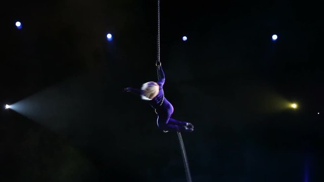 Acrobat with rope in circus
