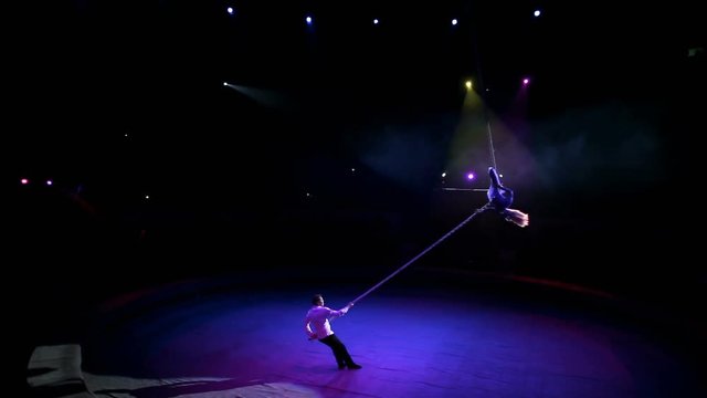 Acrobat with rope in circus