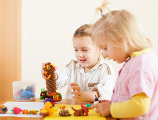 little girls  molding figurines from plasticine