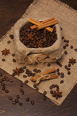 Coffee beans in a wooden box, buckwheat and cinnamon sticks.