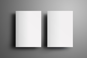 Two universal blank closed A4, (A5) brochures with soft realistic shadows  isolated on gray background. Top of view.