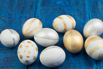 Happy Easter. Painted eggs on wooden table. Top view. Copy space for text.