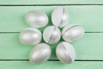 Happy Easter. Painted eggs on wooden table. Top view. Copy space for text.