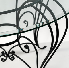 Beautiful curved ornaments of wrought iron. Detail of table