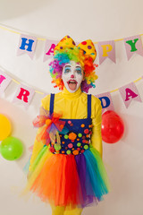 Clowns are a boy and a girl in bright costumes at the child's birthday. The explosion of emotions and the fun of the circus