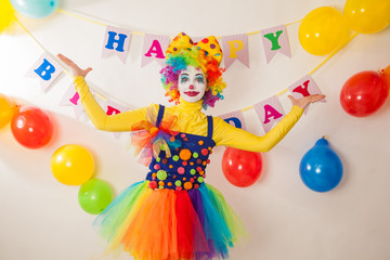 Clowns are a boy and a girl in bright costumes at the child's birthday. The explosion of emotions and the fun of the circus