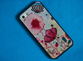 phone in a colored case on a blue background