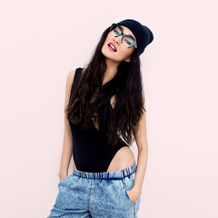 Brunette Girl in black body and beanie cap. Jeans. Tomboy style